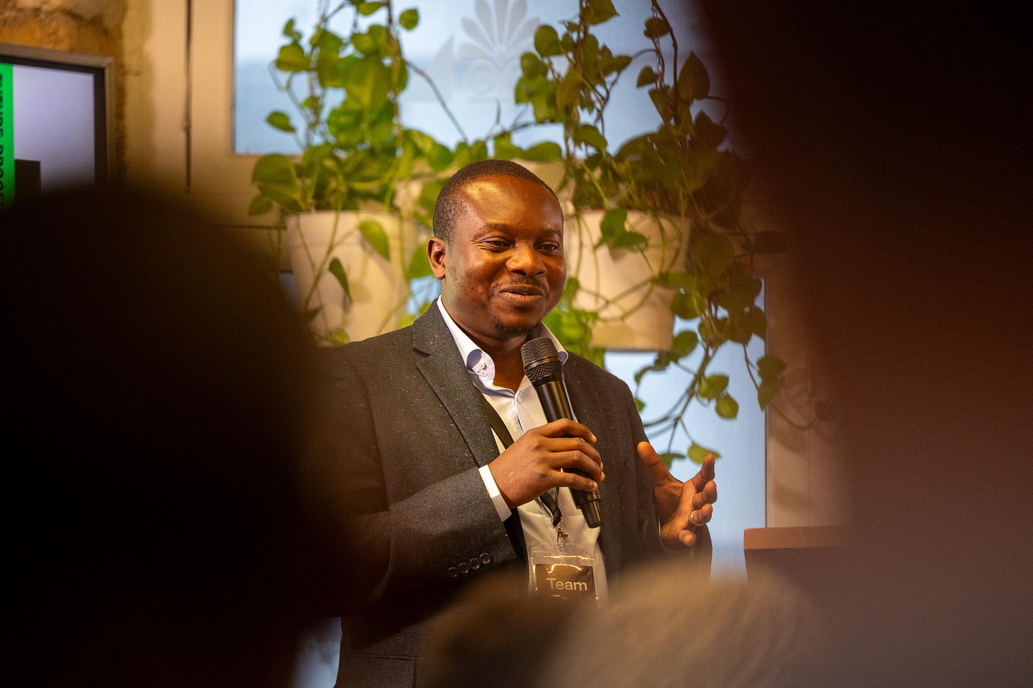A speaker addressing participants at the AGE Summit